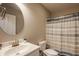 Simple bathroom featuring a sink, toilet and shower with tiled walls and a striped shower curtain at 11880 Whisper Ridge Dr, Noblesville, IN 46060
