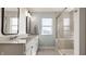 Bright bathroom with double sinks, white cabinetry, light countertops, and a glass shower at 11880 Whisper Ridge Dr, Noblesville, IN 46060