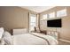 Neutral bedroom featuring an accent chair, flat screen TV, and three windows allowing for natural light at 11880 Whisper Ridge Dr, Noblesville, IN 46060