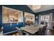 Open dining room with access to kitchen and living room, dark blue accent wall and grill on the porch at 11880 Whisper Ridge Dr, Noblesville, IN 46060