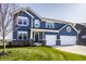 Charming two-story home with a two-car garage, beautiful blue siding and a well-manicured front lawn at 11880 Whisper Ridge Dr, Noblesville, IN 46060