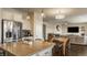 Open concept kitchen features stainless appliances, a large center island and is seamless to the living room and dining at 11880 Whisper Ridge Dr, Noblesville, IN 46060