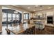 Open-concept kitchen and dining area featuring a large island, stainless steel appliances, and breakfast bar seating at 11880 Whisper Ridge Dr, Noblesville, IN 46060