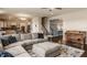 Spacious living room featuring a large sectional sofa, neutral color palette, and seamless flow into the modern kitchen at 11880 Whisper Ridge Dr, Noblesville, IN 46060
