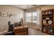 Bright home office featuring a wooden desk, shelving, and neighborhood views at 11880 Whisper Ridge Dr, Noblesville, IN 46060