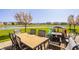 Backyard patio with outdoor dining furniture and a view of the pond at 11880 Whisper Ridge Dr, Noblesville, IN 46060