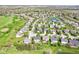 An aerial view shows a residential area with manicured lawns, mature trees, and a neighborhood golf course at 12088 Everwood Cir, Noblesville, IN 46060