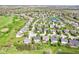 An aerial view shows a residential area with manicured lawns, mature trees, and a neighborhood golf course at 12088 Everwood Cir, Noblesville, IN 46060