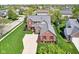 Aerial perspective of a brick home with manicured landscaping, red shutters and a spacious front yard at 12088 Everwood Cir, Noblesville, IN 46060