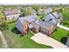 Aerial view of a beautiful home with brick accents, a well-kept lawn, and a long driveway at 12088 Everwood Cir, Noblesville, IN 46060