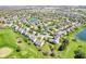 An aerial view of the neighborhood showcases mature trees, manicured lawns, and a community pond at 12088 Everwood Cir, Noblesville, IN 46060