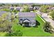 A neatly landscaped backyard with a deck and screened-in porch creates a relaxing outdoor space at 12088 Everwood Cir, Noblesville, IN 46060