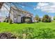 Lush backyard featuring a well-manicured lawn, screened-in porch and pergola for outdoor enjoyment at 12088 Everwood Cir, Noblesville, IN 46060