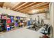 Unfinished basement with exposed ceiling with open storage shelves and home gym equipment at 12088 Everwood Cir, Noblesville, IN 46060
