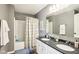 Clean, modern bathroom featuring double sinks, vanity, and tiled shower at 12088 Everwood Cir, Noblesville, IN 46060