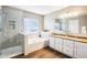 Bright bathroom featuring a double vanity, soaking tub and glass enclosed shower at 12088 Everwood Cir, Noblesville, IN 46060