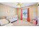 Well-lit Bedroom featuring a ceiling fan, crib, natural light, and colorful decorations at 12088 Everwood Cir, Noblesville, IN 46060