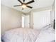 Spacious bedroom with carpet, a dark ceiling fan, closet with white sliding doors, and a comfortable gray bed at 12088 Everwood Cir, Noblesville, IN 46060