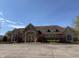 Well-maintained clubhouse with stone accents, arched entryway, beautiful landscaping, and ample parking space at 12088 Everwood Cir, Noblesville, IN 46060