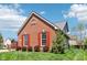 Lovely brick home with red shutters, enhanced by green landscaping and a bright, sunny backdrop at 12088 Everwood Cir, Noblesville, IN 46060