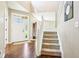 Bright foyer with hardwood floors, a staircase, and a clear view of the front door at 12088 Everwood Cir, Noblesville, IN 46060