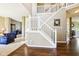 Grand two-story foyer with elegant staircase, hardwood floors, and views into the living spaces at 12088 Everwood Cir, Noblesville, IN 46060