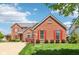 Charming brick home with red shutters and manicured lawn under a blue sky, offering classic curb appeal at 12088 Everwood Cir, Noblesville, IN 46060