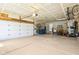 Spacious garage with room for multiple cars and bike racks hanging from the ceiling and walls at 12088 Everwood Cir, Noblesville, IN 46060