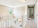 Bright hallway landing featuring chandelier, and natural light coming from a nearby window at 12088 Everwood Cir, Noblesville, IN 46060