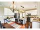Bright kitchen featuring white cabinetry, stainless steel appliances, island, and decorative lighting at 12088 Everwood Cir, Noblesville, IN 46060