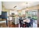 Cozy kitchen with white cabinets, stainless steel appliances, kitchen island, and sliding glass doors to the deck at 12088 Everwood Cir, Noblesville, IN 46060