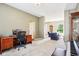 Comfortable living area with large windows, an office desk, and access to other rooms in the house at 12088 Everwood Cir, Noblesville, IN 46060