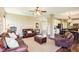 Open-concept living room flows into the dining area, featuring hardwood floors and comfortable seating at 12088 Everwood Cir, Noblesville, IN 46060