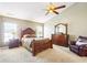 A spacious main bedroom with a ceiling fan, carpet, and ample natural light at 12088 Everwood Cir, Noblesville, IN 46060