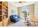 Sunlit office with an arched window, bookcase, and a comfortable seating area at 12088 Everwood Cir, Noblesville, IN 46060