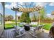 Inviting backyard pergola featuring swings, rocking chairs, and a center table for outdoor relaxation at 12088 Everwood Cir, Noblesville, IN 46060