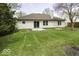 Spacious backyard featuring a well-maintained lawn and patio, offering a relaxing outdoor space at 12249 E Harvest Glen Dr, Cumberland, IN 46229