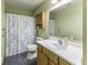 Bathroom featuring a single sink vanity, and a shower/tub with a patterned curtain at 12249 E Harvest Glen Dr, Cumberland, IN 46229