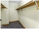 Walk-in closet featuring a light-colored wall and wooden shelving, offering ample storage at 12249 E Harvest Glen Dr, Cumberland, IN 46229