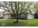 Exterior view of a single-story home featuring mature tree and a well-maintained lawn at 12249 E Harvest Glen Dr, Cumberland, IN 46229