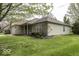 Exterior view of a single-story home featuring a well-maintained lawn at 12249 E Harvest Glen Dr, Cumberland, IN 46229