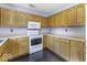 Well-lit kitchen featuring white appliances, and ample counter space at 12249 E Harvest Glen Dr, Cumberland, IN 46229