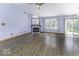 Spacious living room featuring hardwood floors, a cozy fireplace, and large windows at 12249 E Harvest Glen Dr, Cumberland, IN 46229