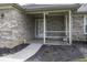 Covered front porch with brick siding, perfect for enjoying the outdoors at 12249 E Harvest Glen Dr, Cumberland, IN 46229