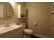 Well lit powder room with vanity, mirror, toilet, and storage cabinet with decor at 12678 Brewton St, Fishers, IN 46038