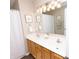 Bright bathroom featuring a double vanity with wooden cabinets, providing ample space for a functional and stylish area at 12678 Brewton St, Fishers, IN 46038