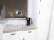 Kitchen breakfast bar with white cabinets and open view of Gathering room at 12678 Brewton St, Fishers, IN 46038