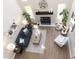 Bright living room boasts soaring ceilings, a cozy fireplace, stylish furniture, and plenty of natural light from large windows at 12678 Brewton St, Fishers, IN 46038