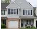 Charming townhome featuring a one-car garage, a cozy front porch, and professionally maintained landscaping at 12678 Brewton St, Fishers, IN 46038