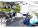 Inviting patio area with comfortable seating, a glass-topped table, a vibrant blue umbrella, and outdoor decor at 12678 Brewton St, Fishers, IN 46038